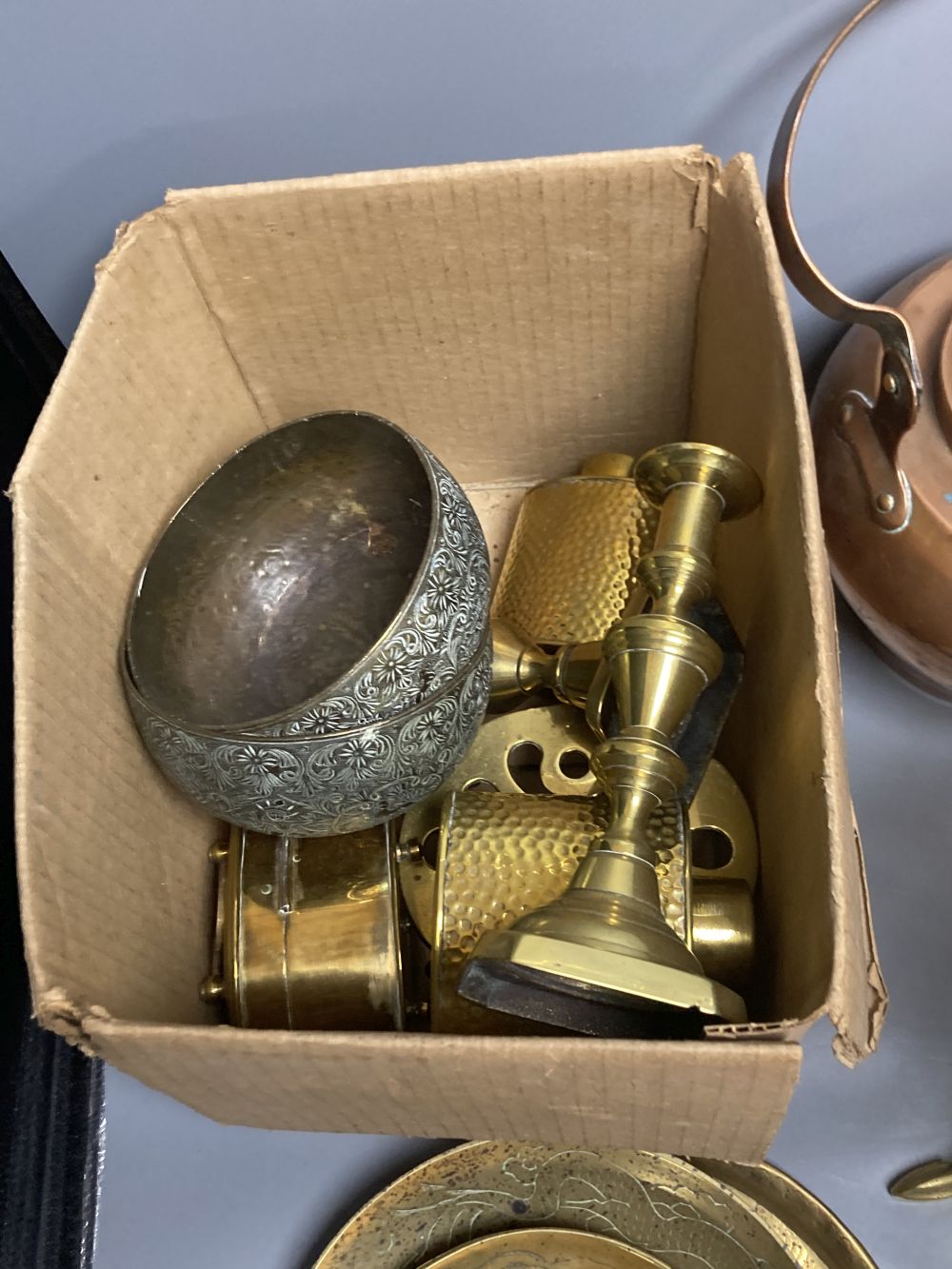 Miscellaneous metalware, including a copper kettle, two pairs of brass candlesticks, a squirrel trivet, tobacco box, etc.